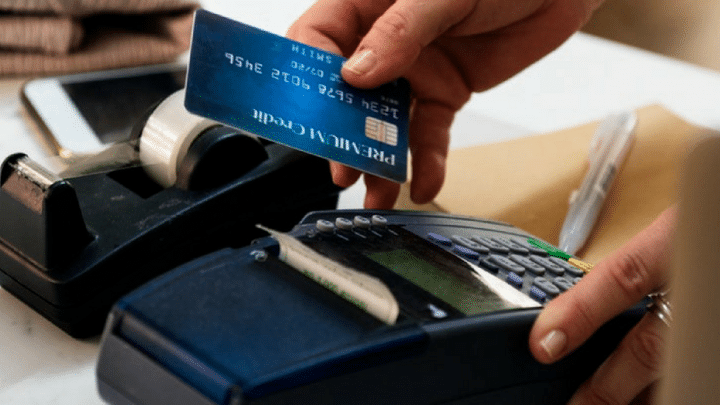 Loyalty Cards | Man sliding credit card through POS machine